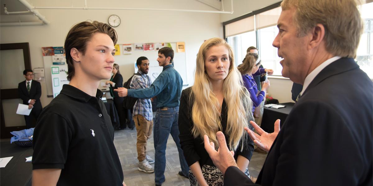 business students in a discussion at business law event