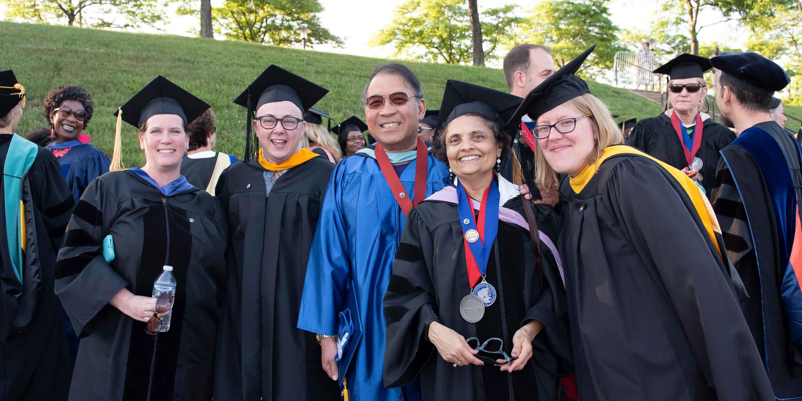 AACC faculty pose at commencement